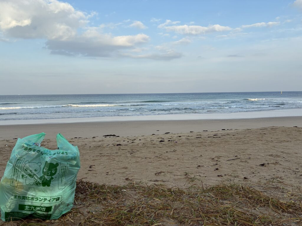 ２０２５年１１月２８日　岩屋海岸清掃活動で回収したボランティア袋と背景に海をセットで撮影した記録